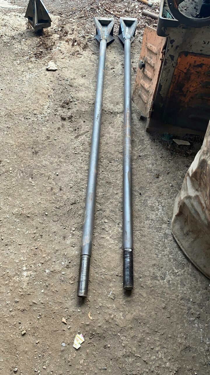Anchor bolt assembly showing full length, rolled thread and welded gusset plate at the embedded end