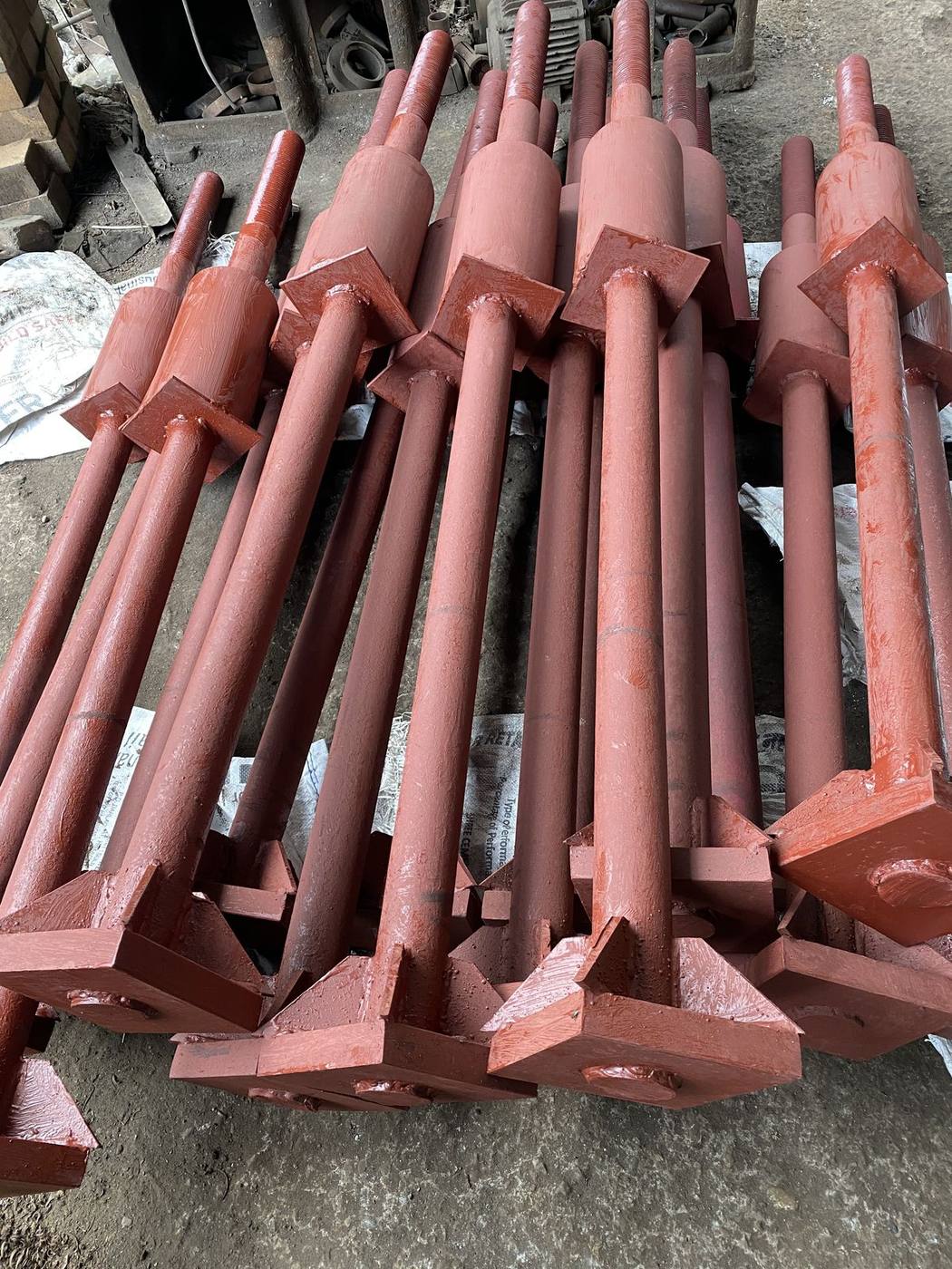 Pipe sleeve and gusset detail on welded plate anchor bolt assemblies, red oxide primed